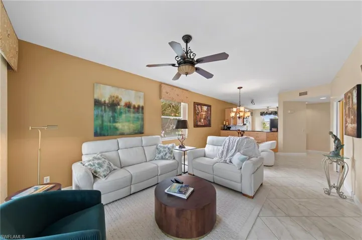 Living room with ceiling fan and hanging lights