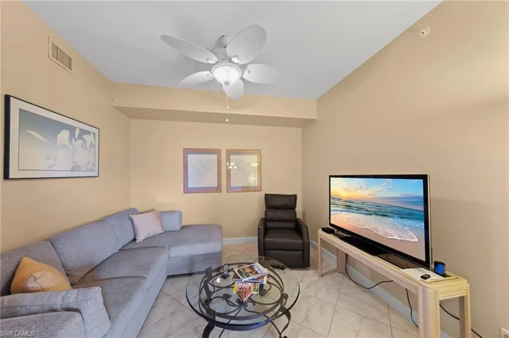 Living room with ceiling fan and baseboards