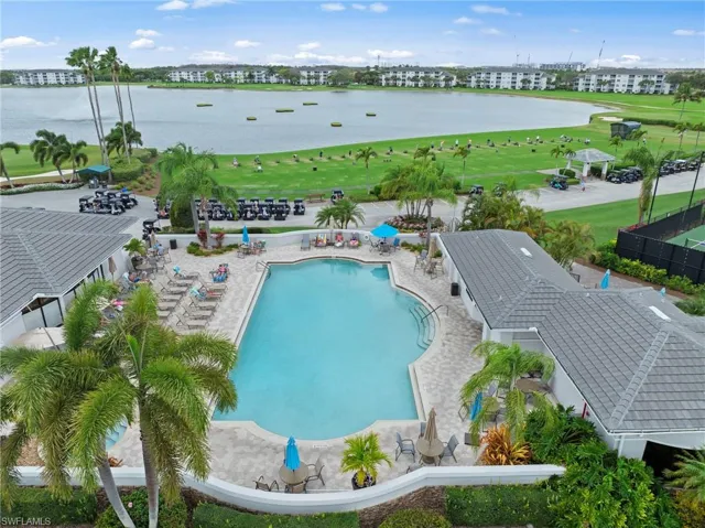 Community pool featuring a patio area, golf course view, and a water view