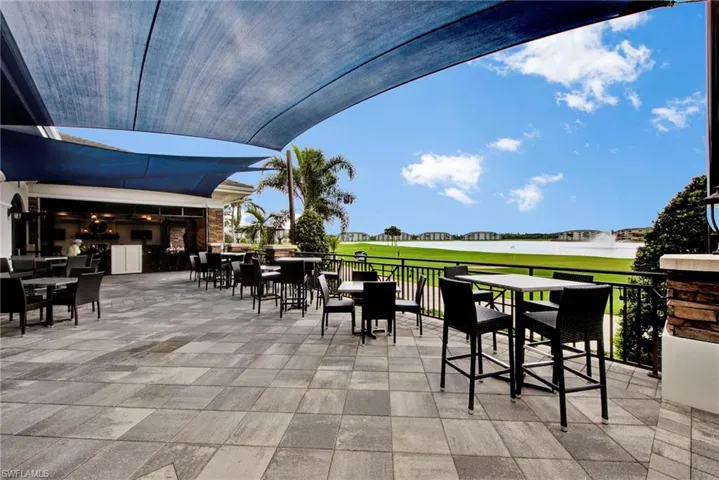View of patio featuring view of golf course and an outdoor kitchen / dining area