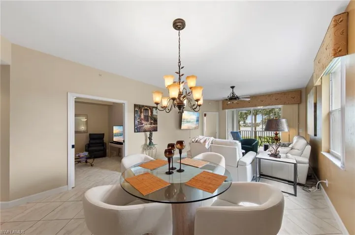 Dining space with a ceiling fan and suspended lighting