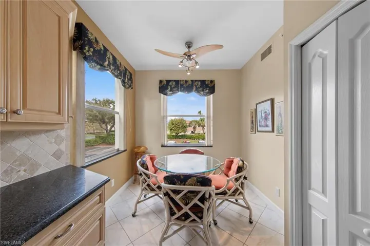 Dining area with a ceiling fan and healthy amount of natural light