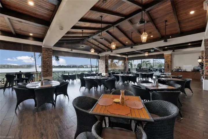 Dining space featuring a high wooden beamed ceiling, dark wood finished floors, and recessed lighting
