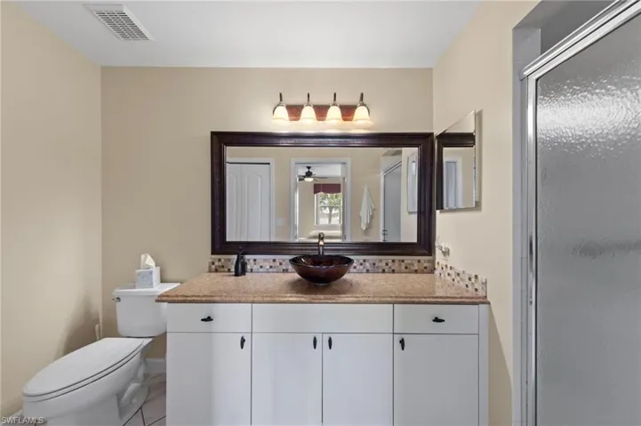 Bathroom featuring vanity and a stall shower