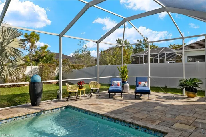 Outdoor pool featuring a lanai, a fenced backyard, a sunroom, and a patio area