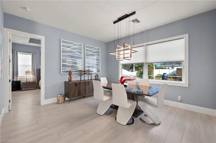Dining area featuring a chandelier and light wood-style flooring