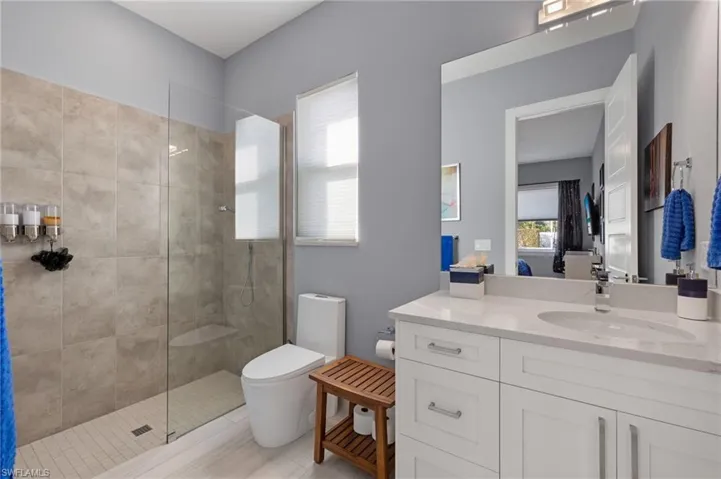 Bathroom with vanity, a walk in shower, and ensuite bath