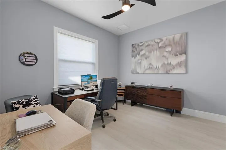 Office area featuring a ceiling fan and light wood-type flooring
