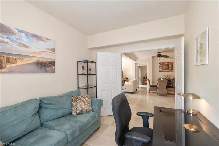 Home office with tile patterned flooring and ceiling fan