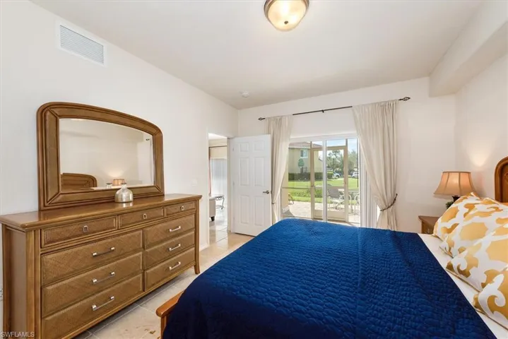 Bedroom with access to exterior and light tile patterned flooring