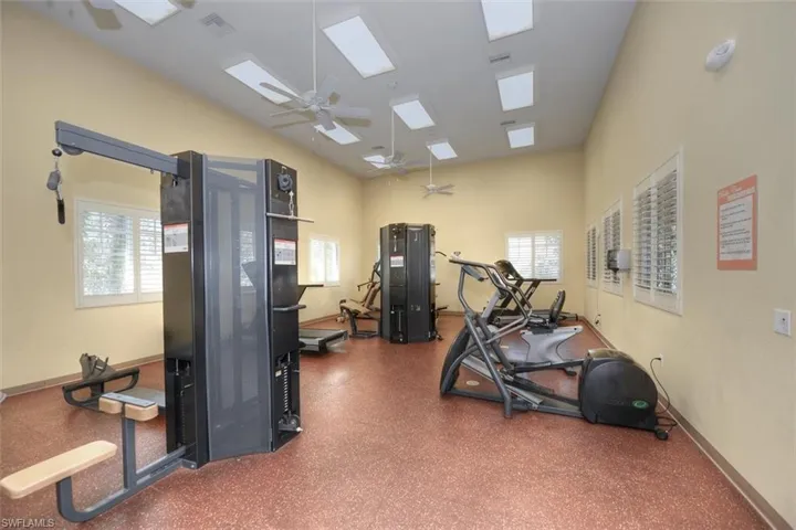 Workout area with ceiling fan and a skylight