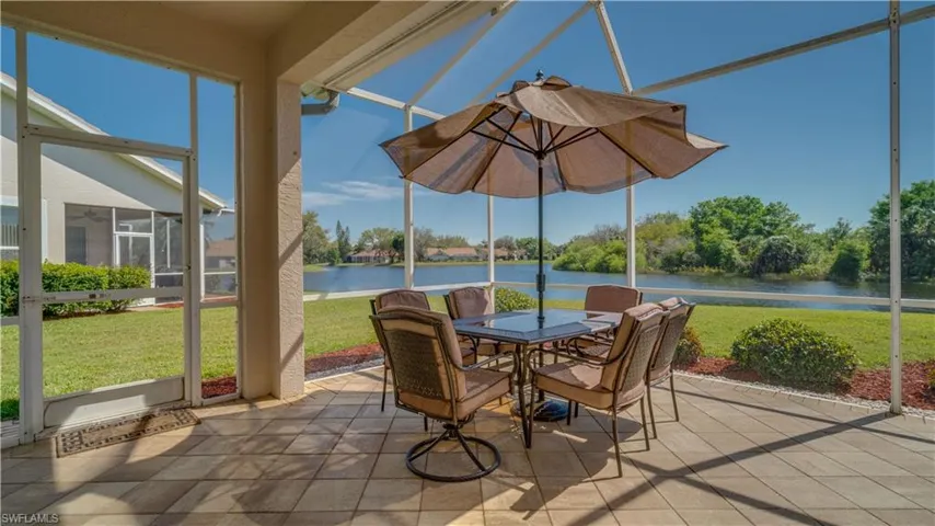 Sunroom featuring a water view and outdoor dining area