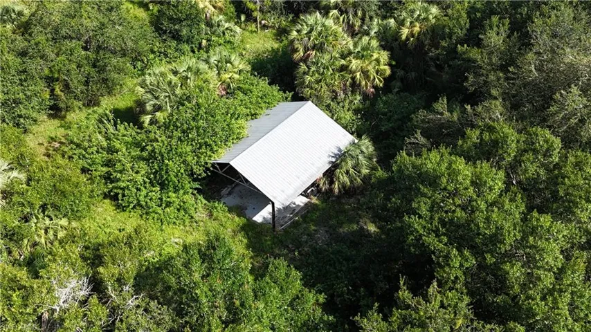 View of subject property featuring a heavily wooded area
