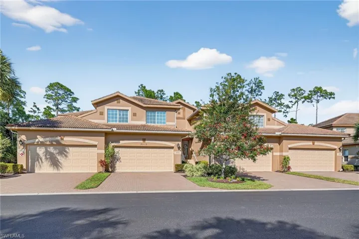 Mediterranean / spanish home featuring stucco siding, a tiled roof, and driveway