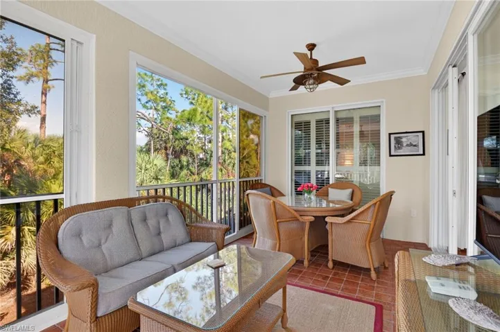 Sunroom featuring ornamental molding and tile patterned flooring