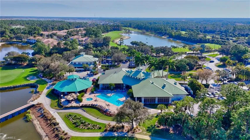 Aerial perspective of suburban area featuring a large body of water and a local golf course