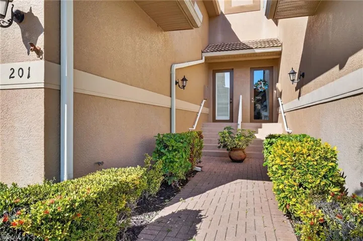 Property entrance featuring stucco siding