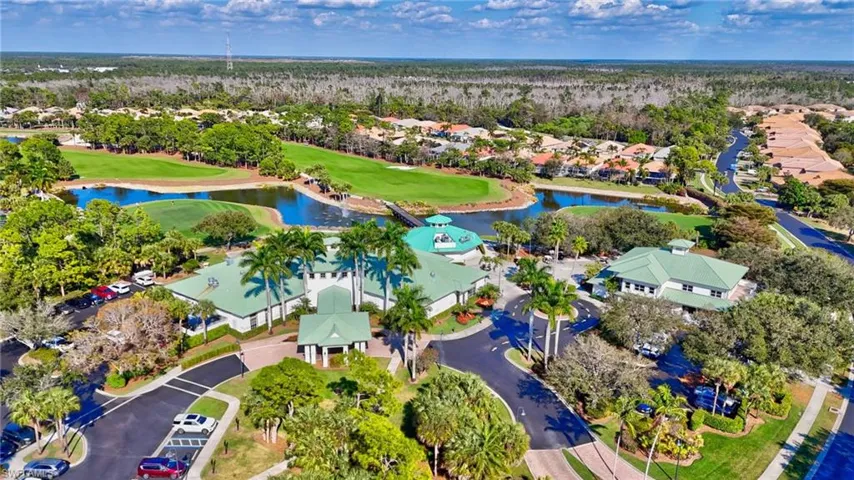 Aerial perspective of suburban area with a nearby body of water and a golf club