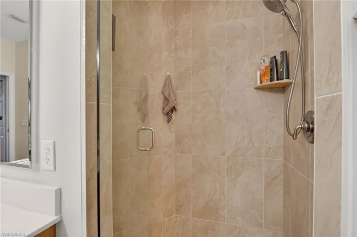 Bathroom with a stall shower and vanity