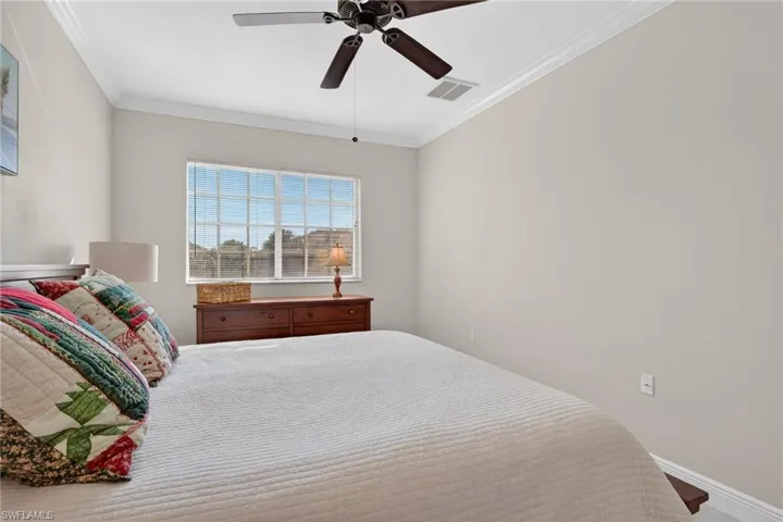 Bedroom featuring ornamental molding and ceiling fan