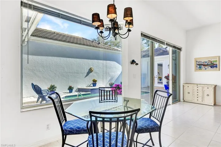 Charming breakfast nook with beautiful natural light and pool views.