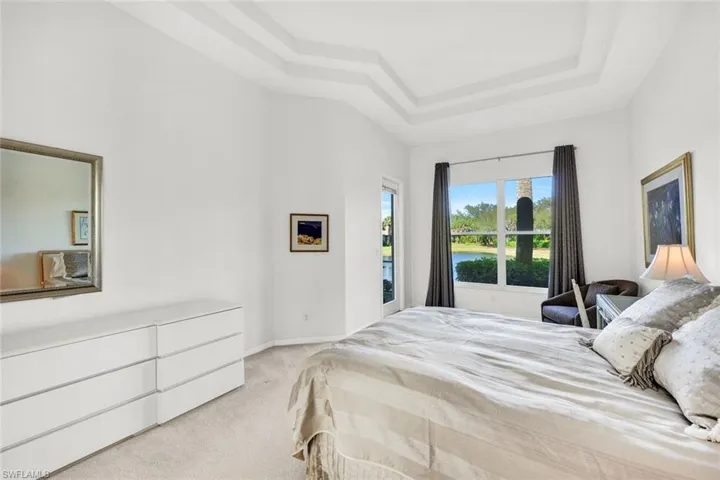 Primary suite features lake views and lanai access.