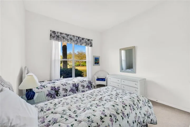 Guest bedroom features lake views.