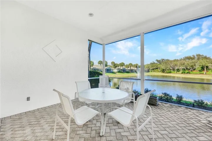 Enclosed lanai offers serene lake views and a peaceful retreat.