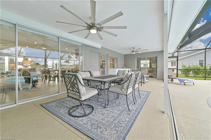 Sunroom featuring ceiling fan and outdoor dining area