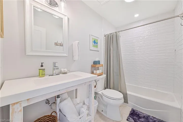 Bathroom with shower / tub combo with curtain, tile patterned flooring, vanity, and recessed lighting