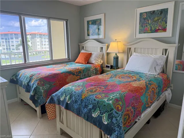 Bedroom with baseboards and light tile patterned floors