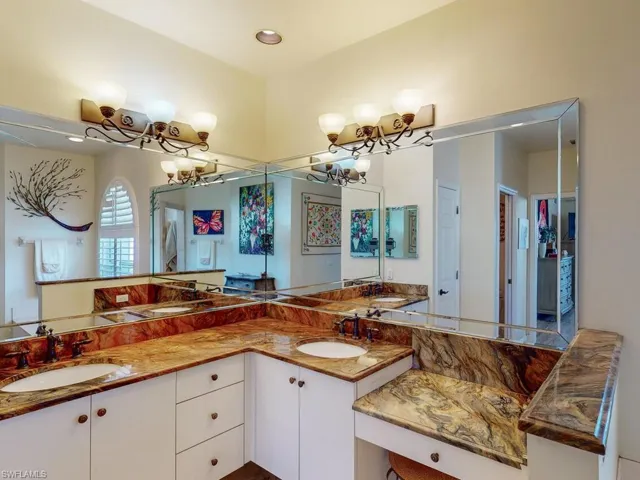 Bathroom featuring vanity and a notable chandelier