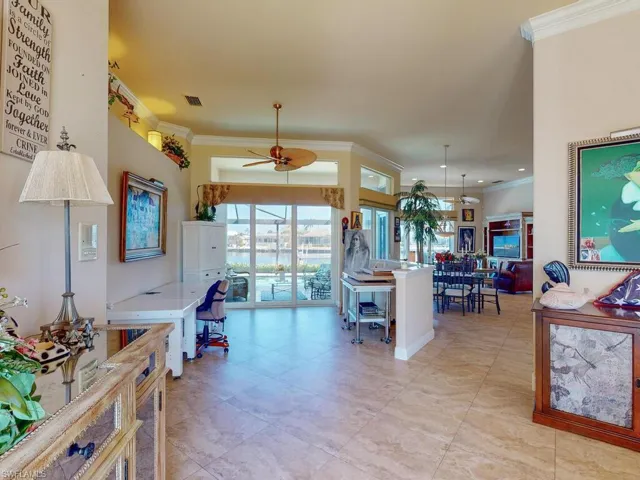 Kitchen featuring ornamental molding and ceiling fan