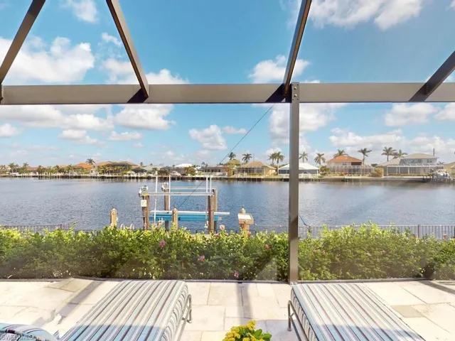 View of patio featuring a boat dock and a water view
