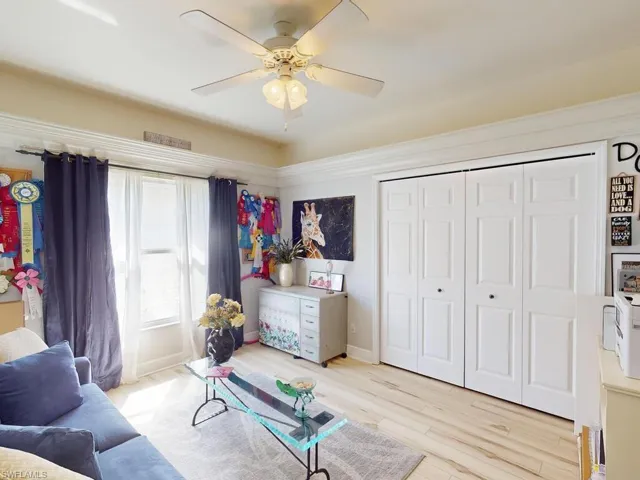 Sitting room featuring ceiling fan and light wood-type flooring