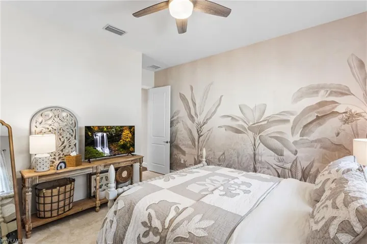 Bedroom with ceiling fan and carpet flooring