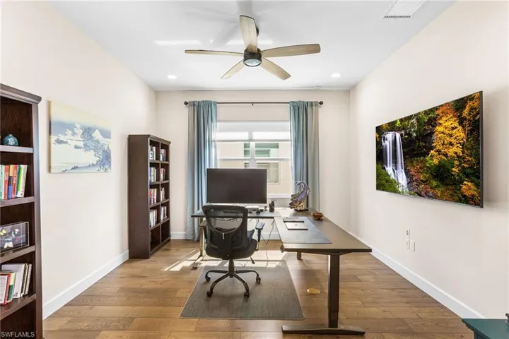 Office space featuring hardwood / wood-style flooring, ceiling fan, and recessed lighting