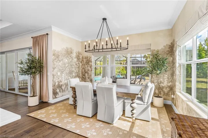 Dining area featuring a chandelier, crown molding, and wood finished floors