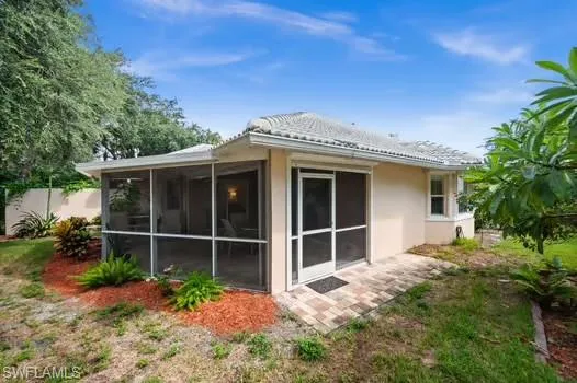 Rear view of property with stucco siding and a patio area