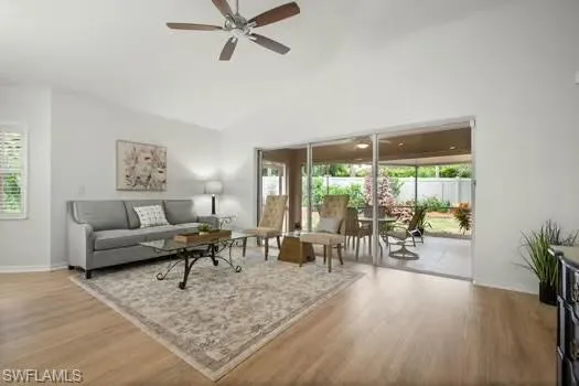 Living area featuring wood finished floors, healthy amount of natural light, and ceiling fan