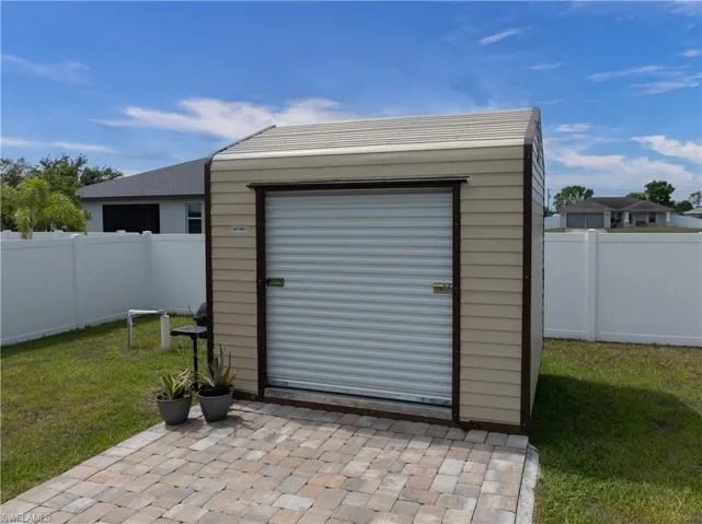 Utility Shed with Overhead Door and 10x10 Paver Pad
