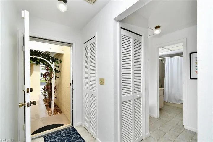 Hall featuring light tile flooring
