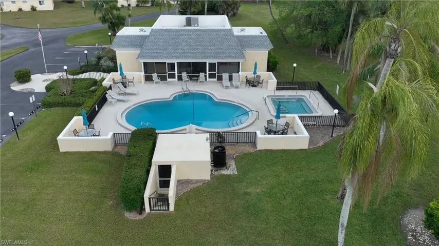 View of community pool with a patio area and a lawn