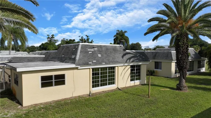Back of house featuring a lawn