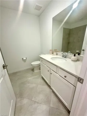 Full bathroom with vanity and light tile patterned floors