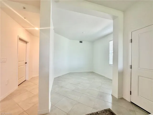 Unfurnished room featuring baseboards and light tile patterned floors
