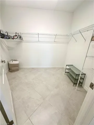 Walk in closet featuring light tile patterned flooring