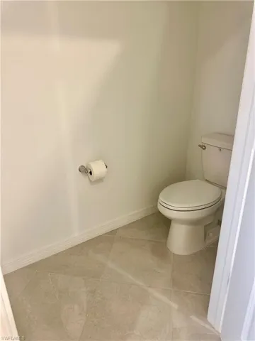 Bathroom with baseboards and tile patterned floors