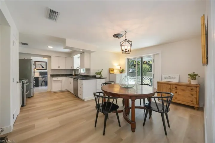 Kitchen has granite counters and an eat-in dining area