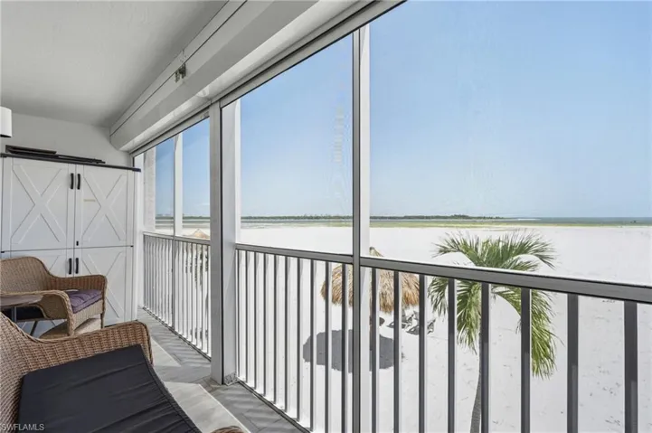 Screened balcony with white sand beach and ocean scenery - Virtually Edited Image